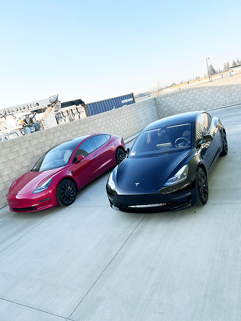 Two Tesla vehicles outside NeuTEK Customs
